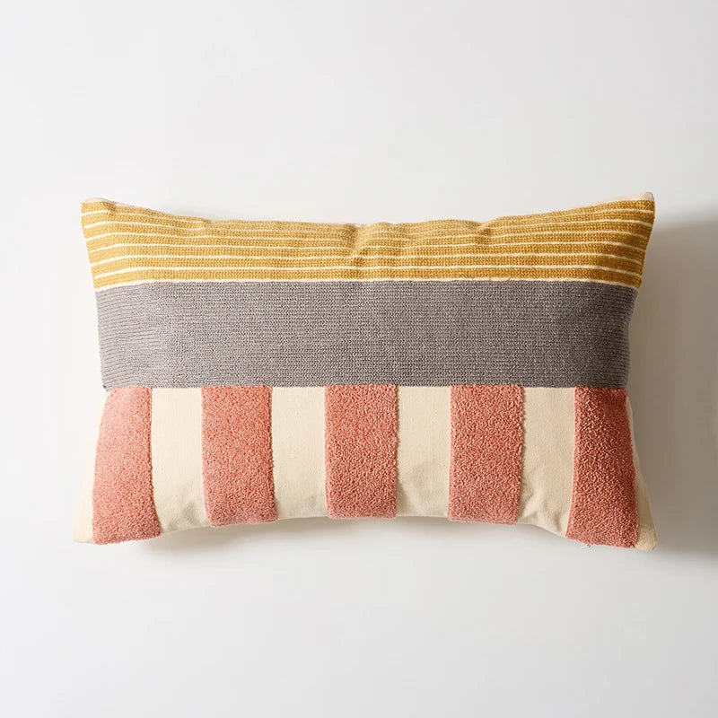 Striped pillow with yellow, gray, pink, and beige colors on a white background Colorful abstract geometric embroidered cushion cover in cotton blend, decorative pillowcase for living room, kids’ room, or boho home decor.