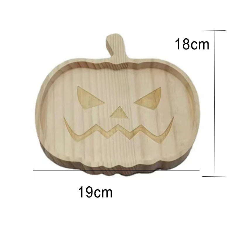 Wooden pumpkin-shaped cutting board with carved face design and measurements on a white background. Wooden Halloween serving tray in pumpkin and ghost shapes, rustic snack and dessert plate for party décor and fall entertaining