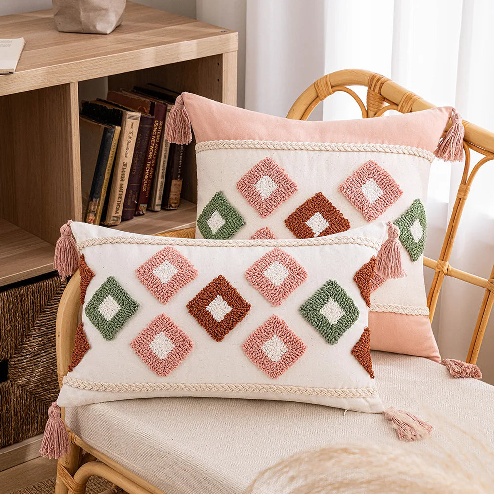 Decorative pillows with geometric patterns on a chair next to a bookshelf. Decorative tassel cushion cover