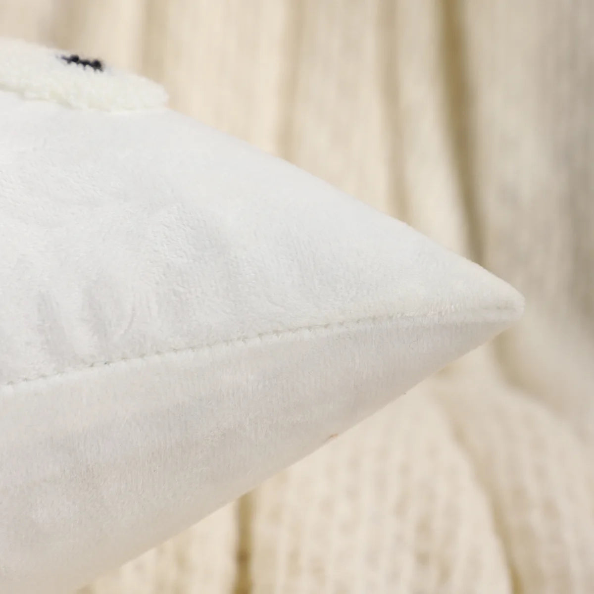 Close-up of a white pillow on a beige background