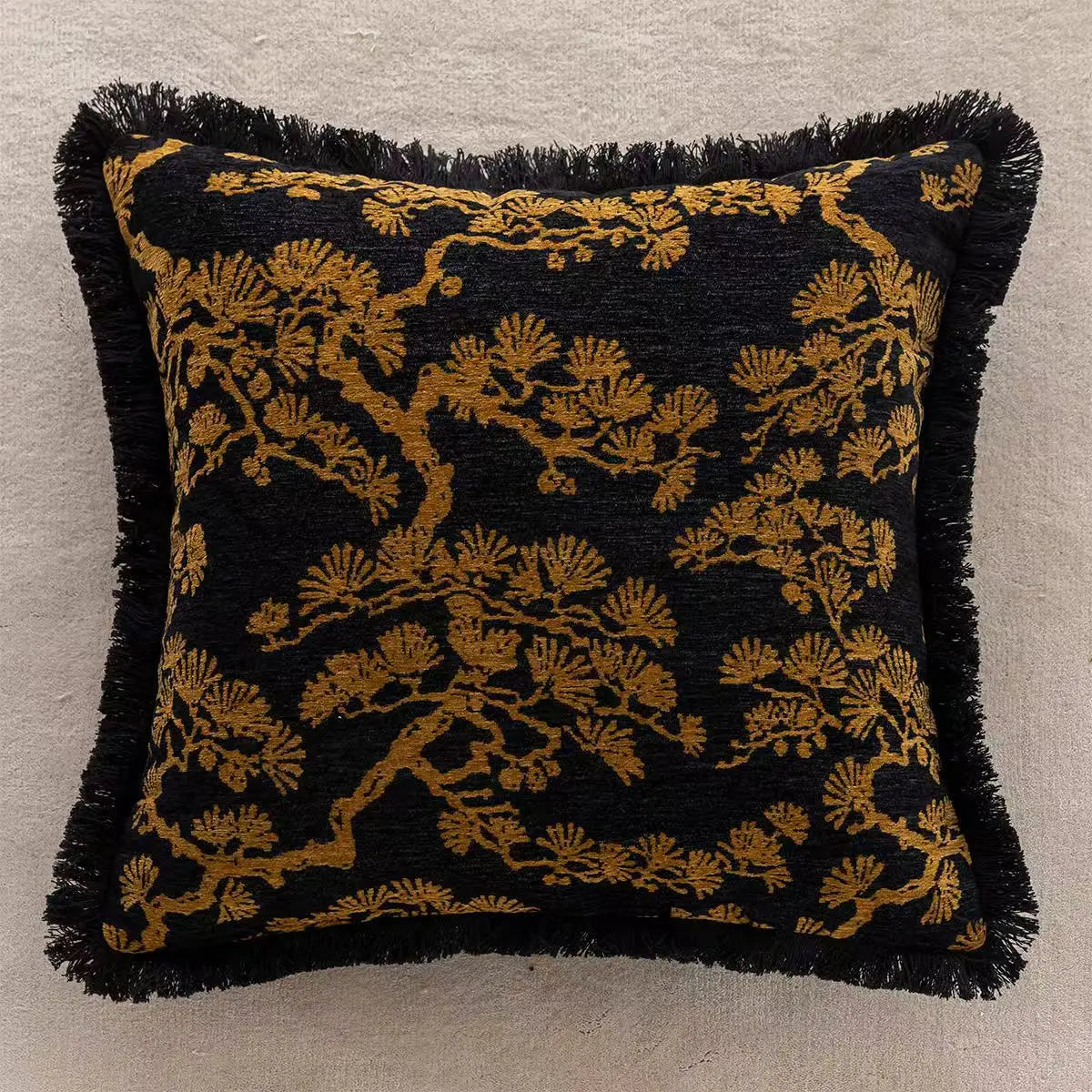 Decorative pillow with black and gold pattern on a neutral background. embroidery throw pillow cover in boho modern style