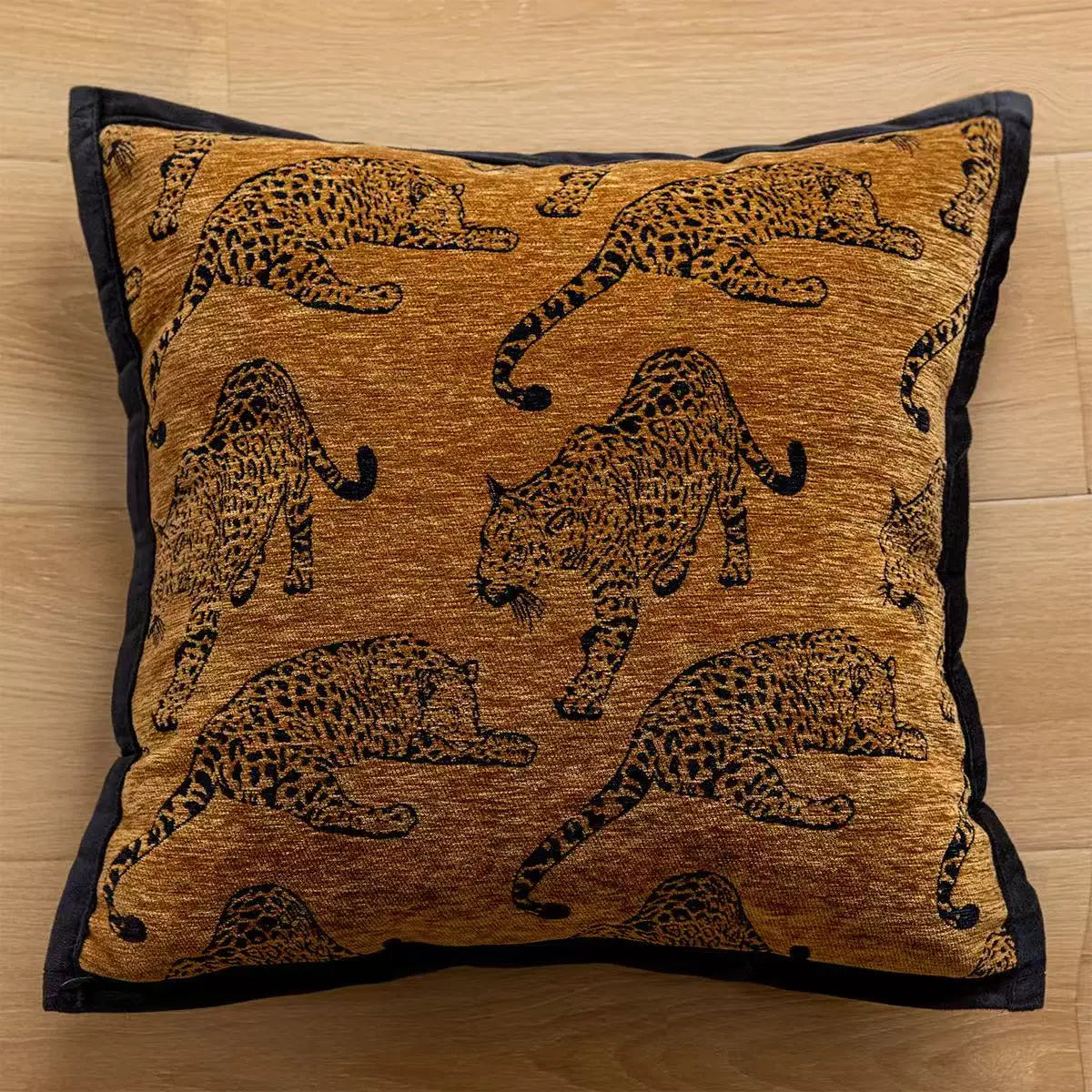 Decorative pillow with leopard patterns on a wooden surface. embroidery throw pillow cover in boho modern style.