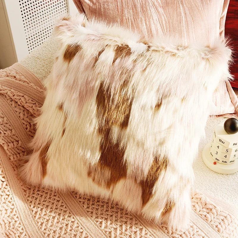 Furry pillow on a textured surface with a blurred background. Boho Home Decor.