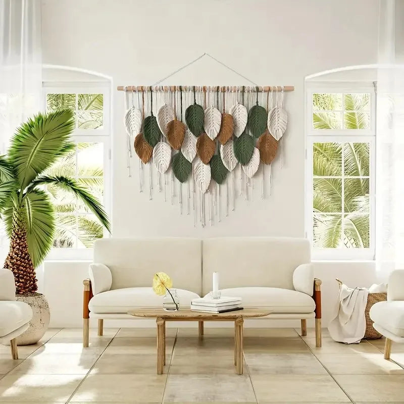 Decorative wall hanging above a white sofa in a bright living room with large windows.