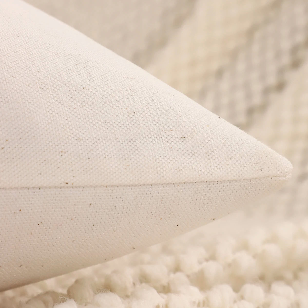 Close-up of a textured beige pillow on a soft surface. Christmas embroidered pillow cover with tufted snowflake and reindeer design in 18x18 inches, festive canvas cushion case for sofa or bed