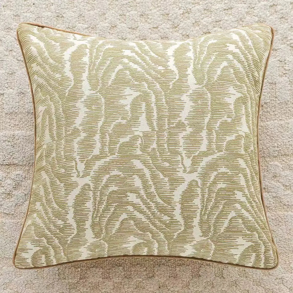 Decorative pillow with a leaf pattern on a textured surface.embroidery throw pillow cover in boho modern style