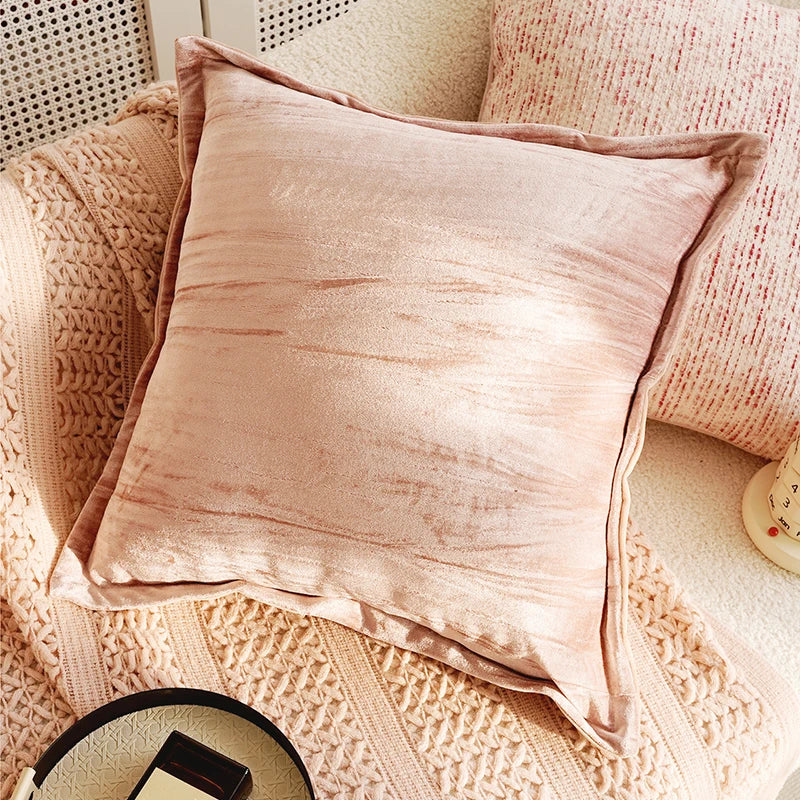 Pink textured pillow on a textured surface. Boho Home Decor.