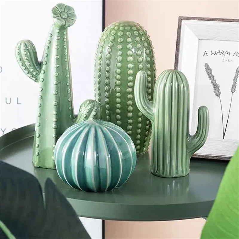 Set of green ceramic cacti on a table with a blurred background. Modern ceramic cactus figurine for home or office decoration