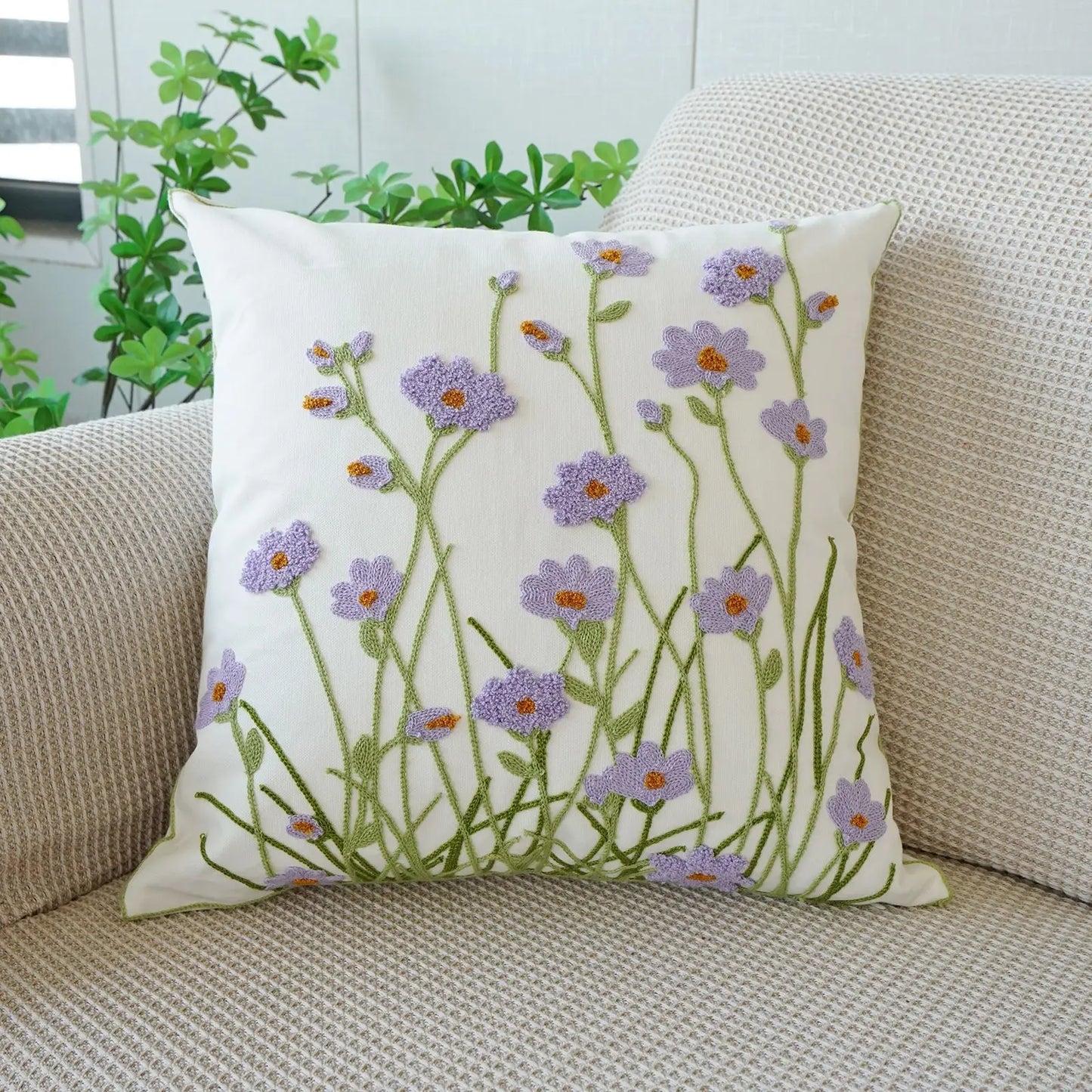 Decorative pillow with floral pattern on a beige couch. Floral embroidered throw pillow cover boho decor