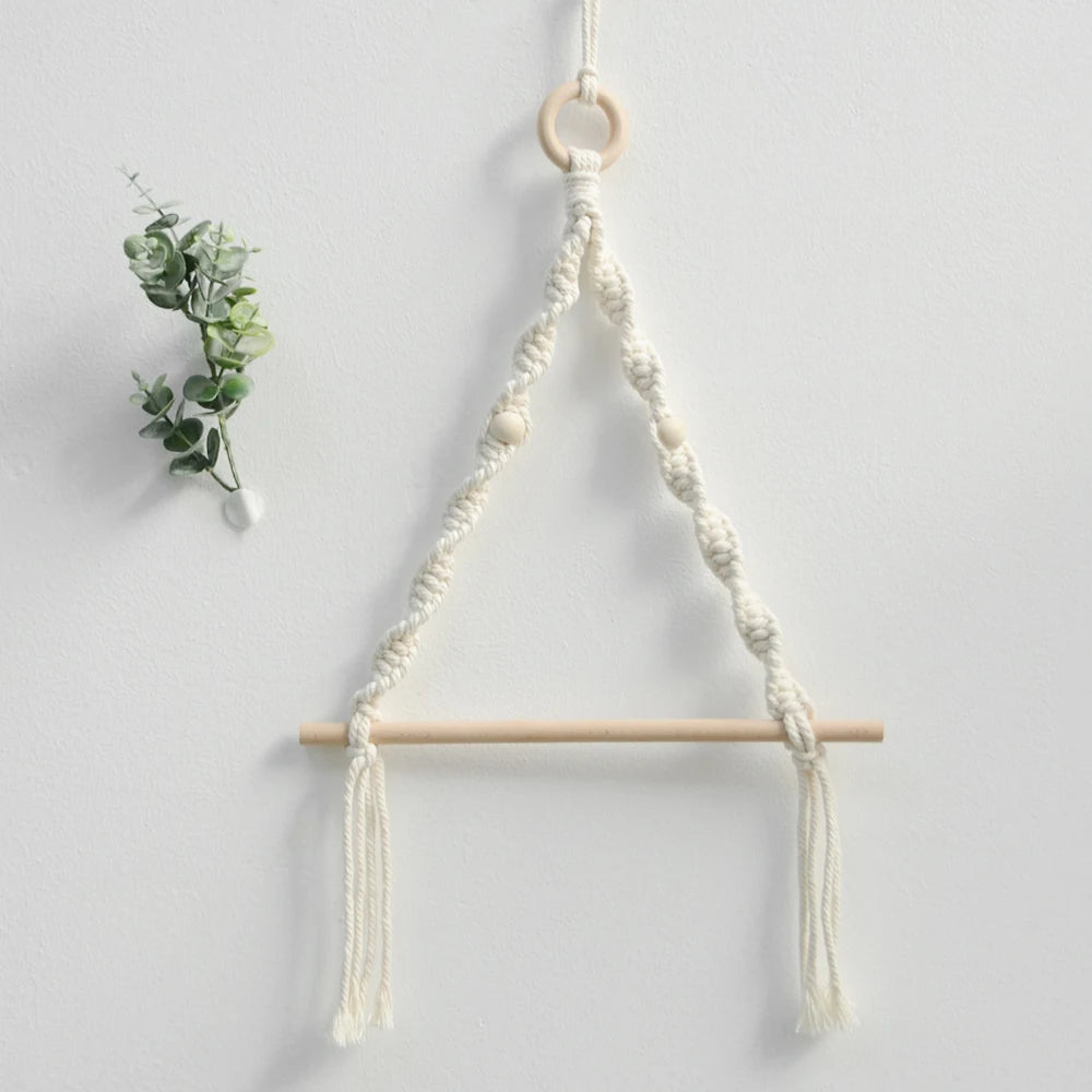 Macrame plant hanger with wooden rod on a light gray background boho home decor, toilet paper holder, bohemian bathroom accessory, tissue holder, wall-mounted towel rack, cotton rope toilet paper rack, wooden bead towel holder, rustic home decor, boho wall decor, bathroom organization, housewarming gift