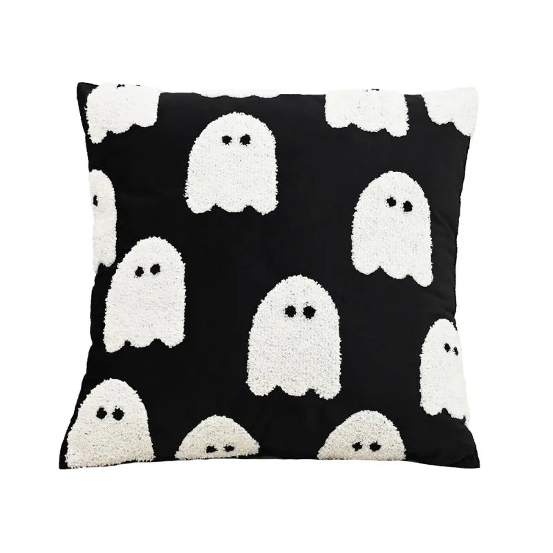Black pillow with white ghost patterns on a white background