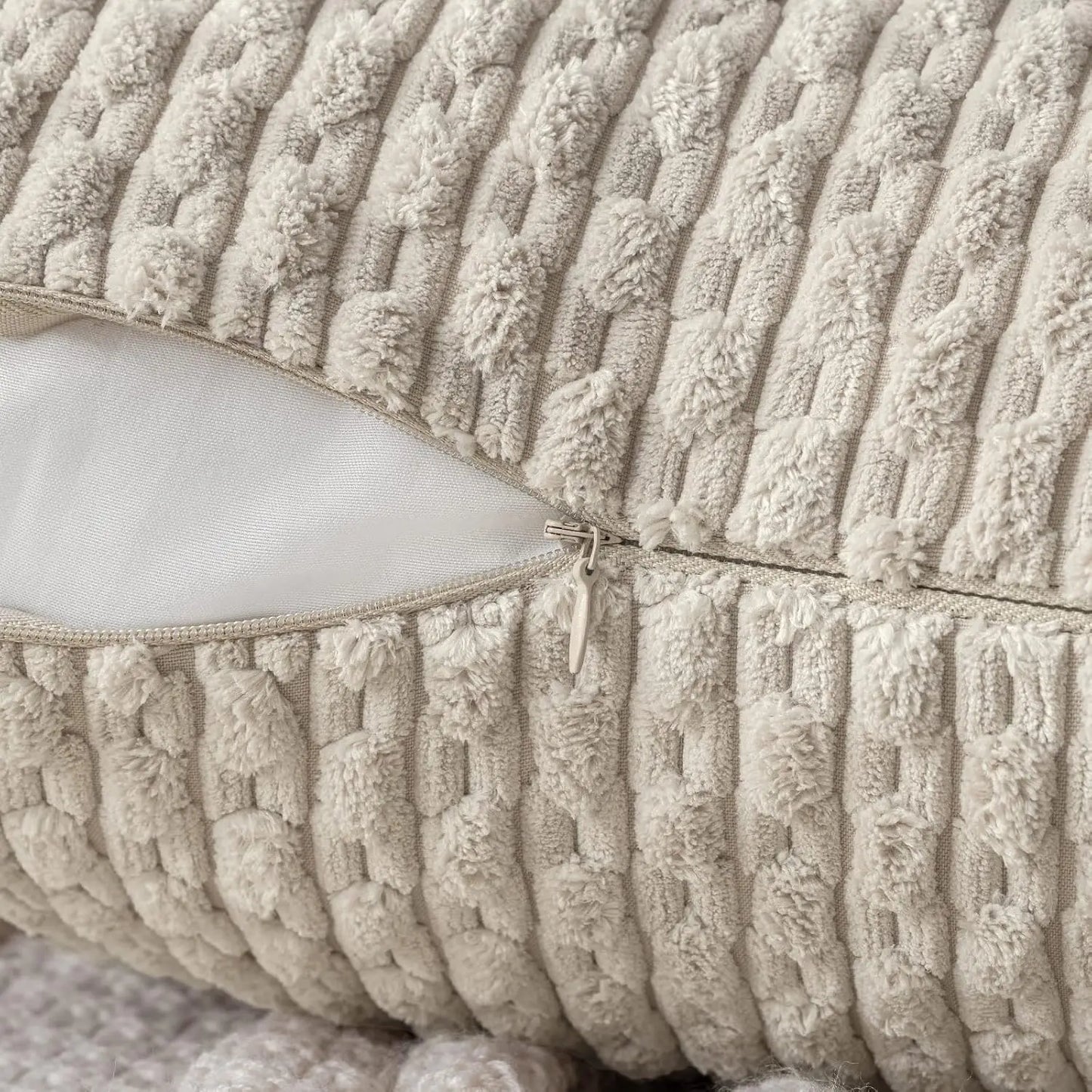 Close-up of textured beige pillow with zipper