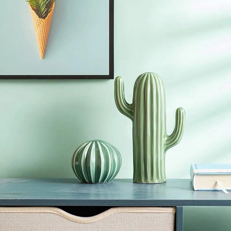 Two green cactus-shaped vases on a shelf with a light green wall in the background. Boho Nordic cactus decor prop for photography and interiors
