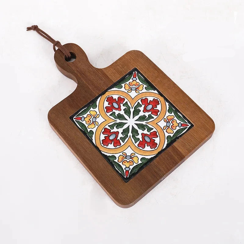 Wooden cutting board with decorative tile design on a white background