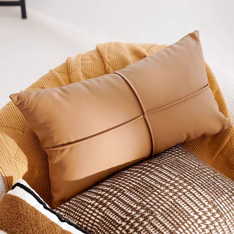 Brown pillow on a textured chair with a neutral background