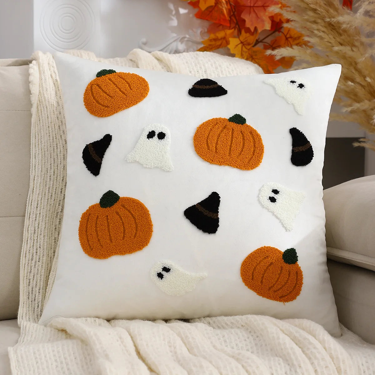 Decorative pillow with Halloween-themed patterns on a couch.