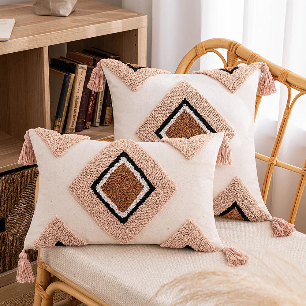 Decorative pillows with geometric patterns and tassels on a chair. Decorative tassel cushion cover
