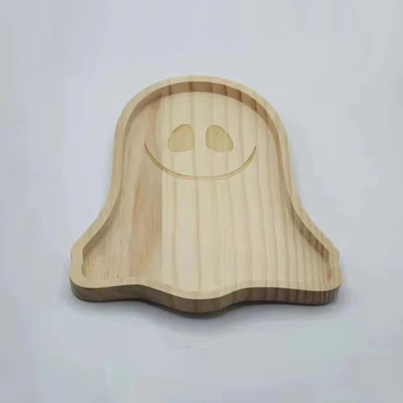 Wooden ghost-shaped tray on a white background. Wooden Halloween serving tray in pumpkin and ghost shapes, rustic snack and dessert plate for party décor and fall entertaining