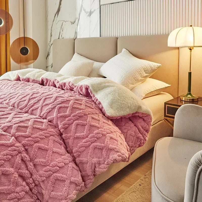 Pink textured blanket on a bed in a cozy bedroom setting with a lamp and nightstand. Soft plush duvet cover and blanket in solid color with striped jacquard design, dual-use artificial cashmere fleece bedding for cozy winter warmth