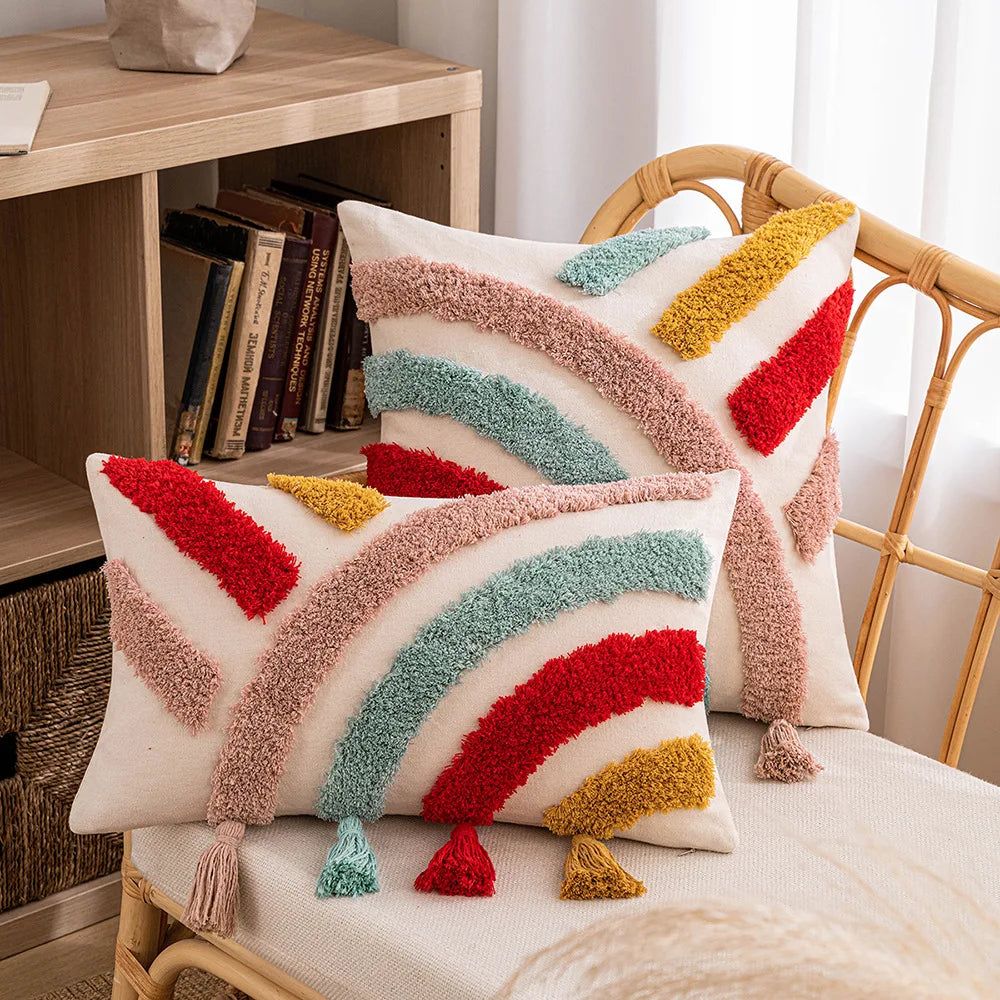 Colorful striped pillows on a chair with a bookshelf in the background. Embroidered boho home décor pillowcase cotton blend