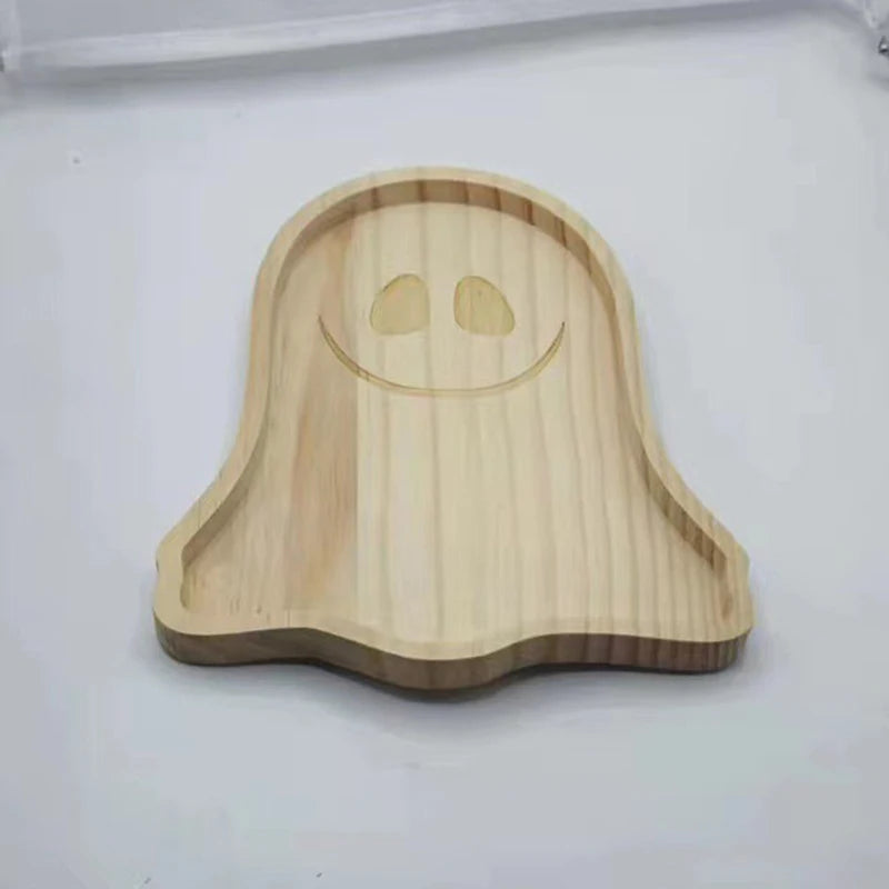 Wooden ghost-shaped tray on a white background. Wooden Halloween serving tray in pumpkin and ghost shapes, rustic snack and dessert plate for party décor and fall entertaining