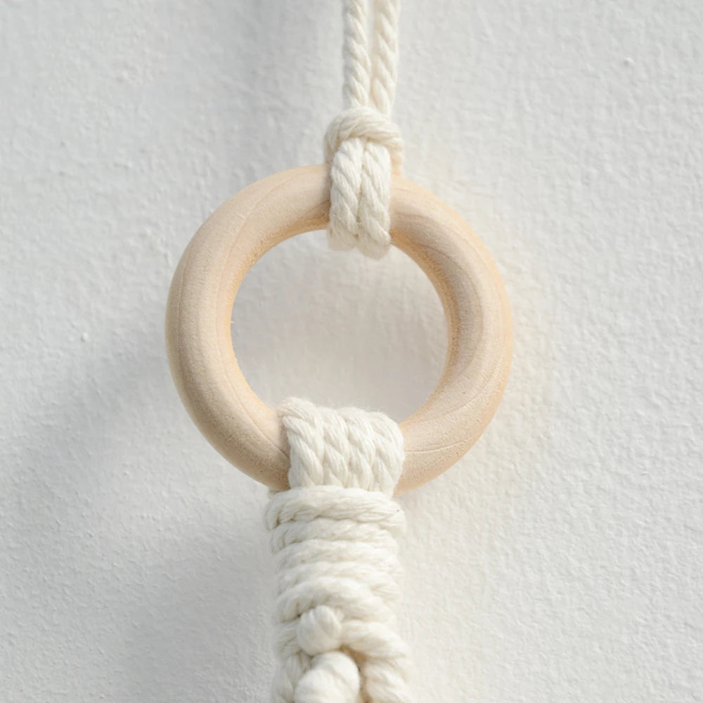Close-up of a wooden ring with white macramé cord on a light gray background boho home decor, toilet paper holder, bohemian bathroom accessory, tissue holder, wall-mounted towel rack, cotton rope toilet paper rack, wooden bead towel holder, rustic home decor, boho wall decor, bathroom organization, housewarming gift