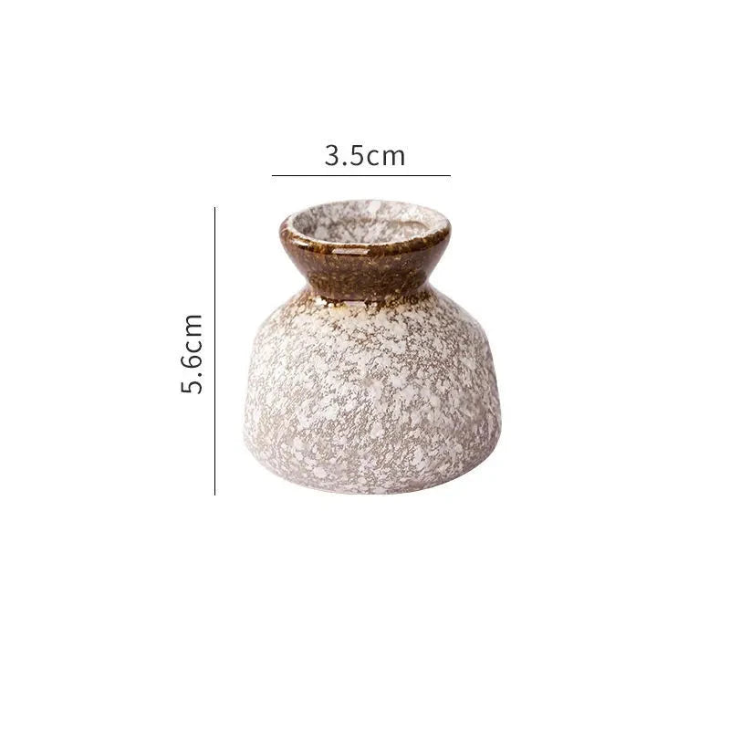 Small decorative vase with dimensions on a white background