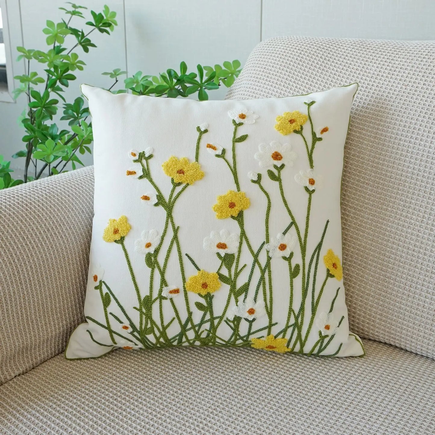 Decorative pillow with floral pattern on a beige couch. Floral embroidered throw pillow cover boho decor