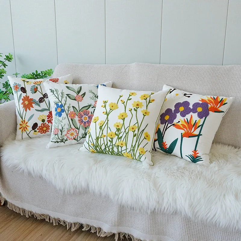 Floral-patterned cushions on a beige sofa with a white fur throw. Floral embroidered throw pillow cover boho decor