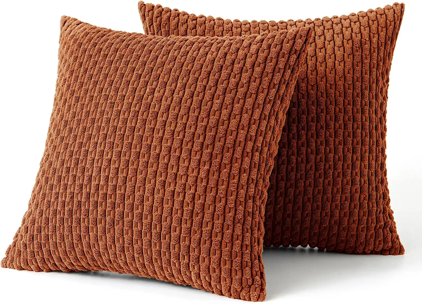 Two brown orange rust textured pillows on a white background