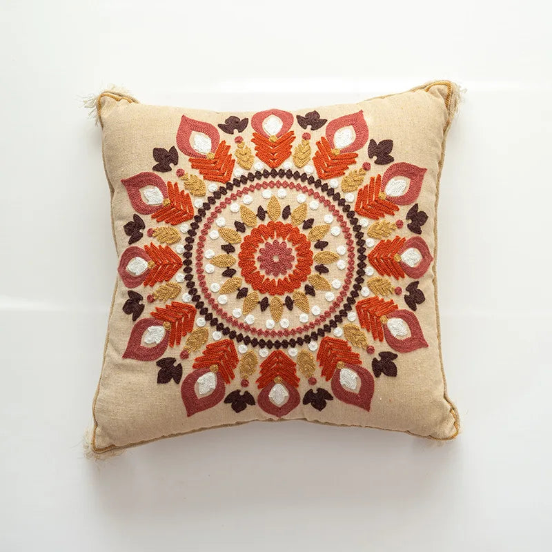 Decorative pillow with intricate embroidery on a beige background
