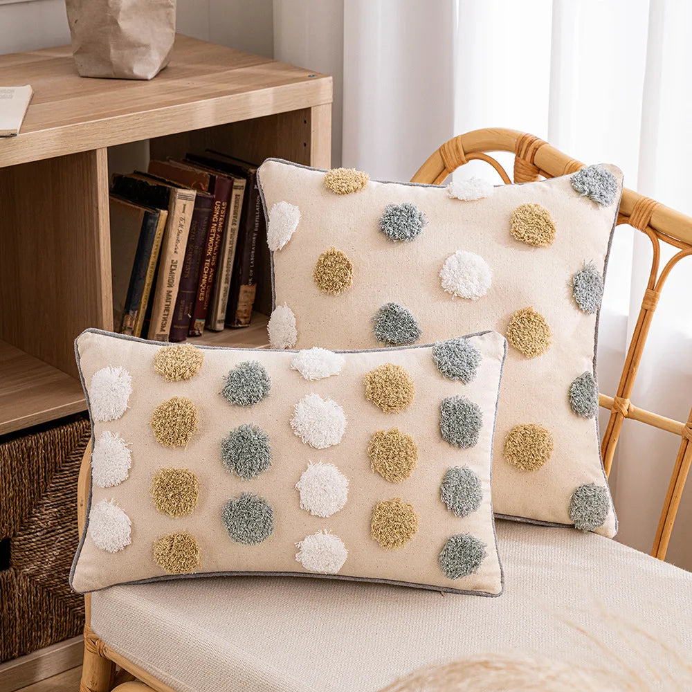 Decorative pillows with pom-pom patterns on a chair next to a bookshelf. Boho cushion cover for sofa, bed, or chair 18x18 inch