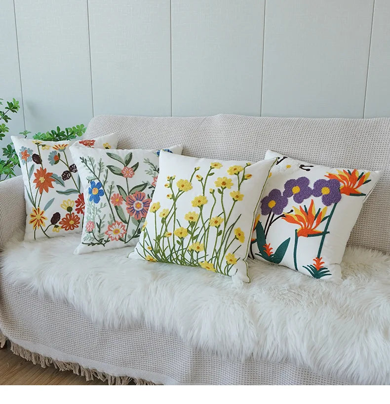 Floral-patterned cushions on a sofa with a light background. Floral embroidered throw pillow cover boho decor