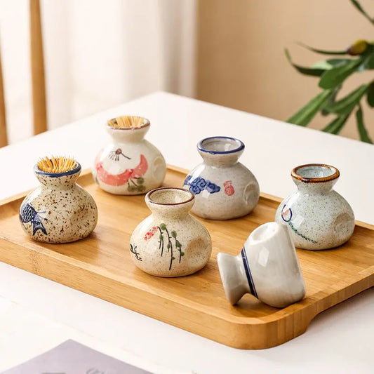 Set of small ceramic vases with decorative designs on a wooden tray.