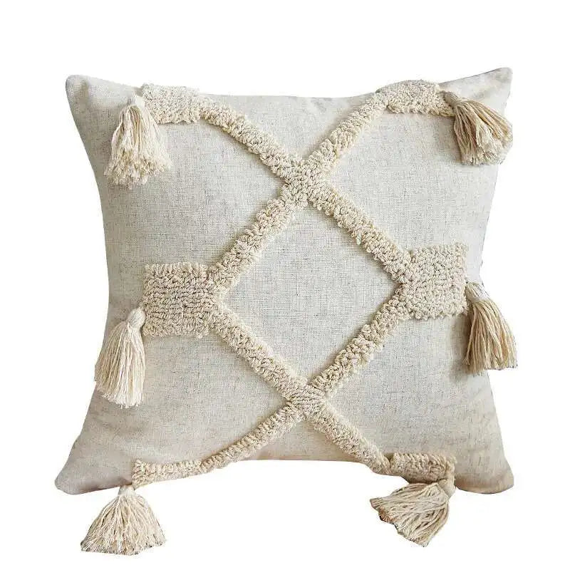 Decorative boho pillow with geometric pattern and tassels on a white background