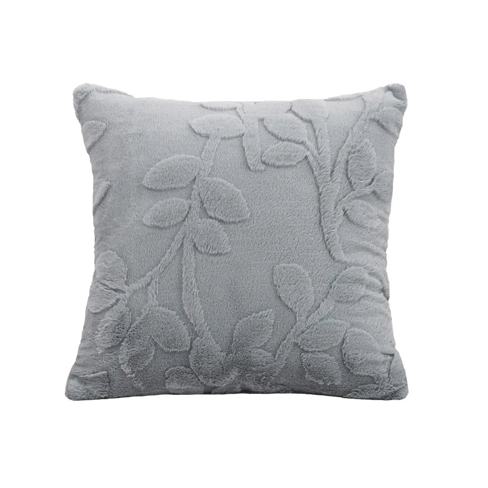 Gray decorative pillow with floral patterns on a white background. Modern jacquard leaf throw pillow cover, woven floral decorative cushion for sofa, bed, or living room in neutral and soft tones.