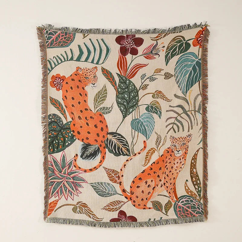 Decorative throw blanket with leopards and floral patterns on a beige background. Boho Home Decor.