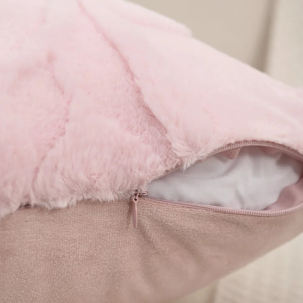 Close-up of a pink plush cushion with a zipper on a neutral background. Modern jacquard leaf throw pillow cover, woven floral decorative cushion for sofa, bed, or living room in neutral and soft tones.