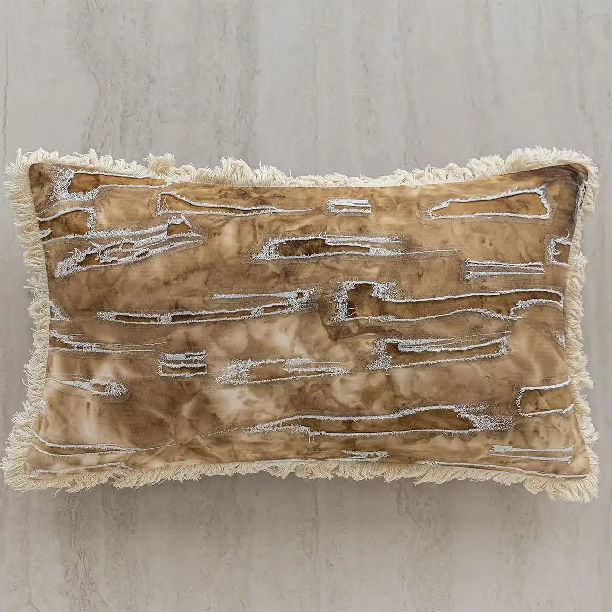 Decorative pillow with textured surface and fringes on a neutral background. embroidery throw pillow cover in boho modern style