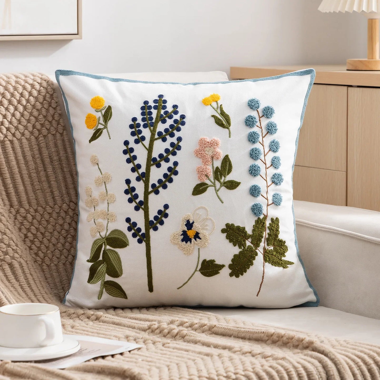 Decorative pillow with floral embroidery on a couch Embroidered flower pillow cover, 17.7-inch square canvas cushion case with floral design for sofa, bed, and boho home decor