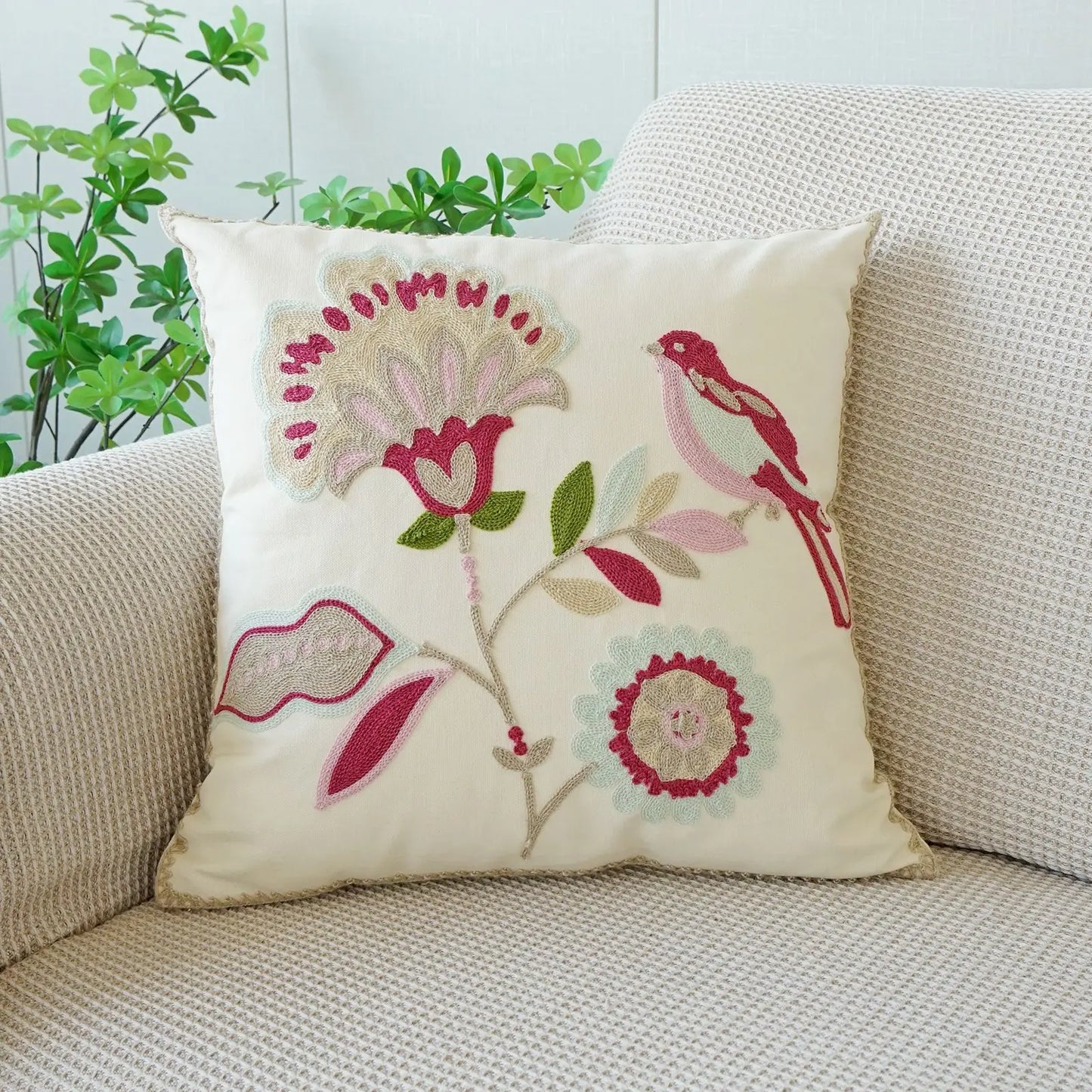 Decorative pillow with floral and bird design on a couch. Floral embroidered throw pillow cover boho decor