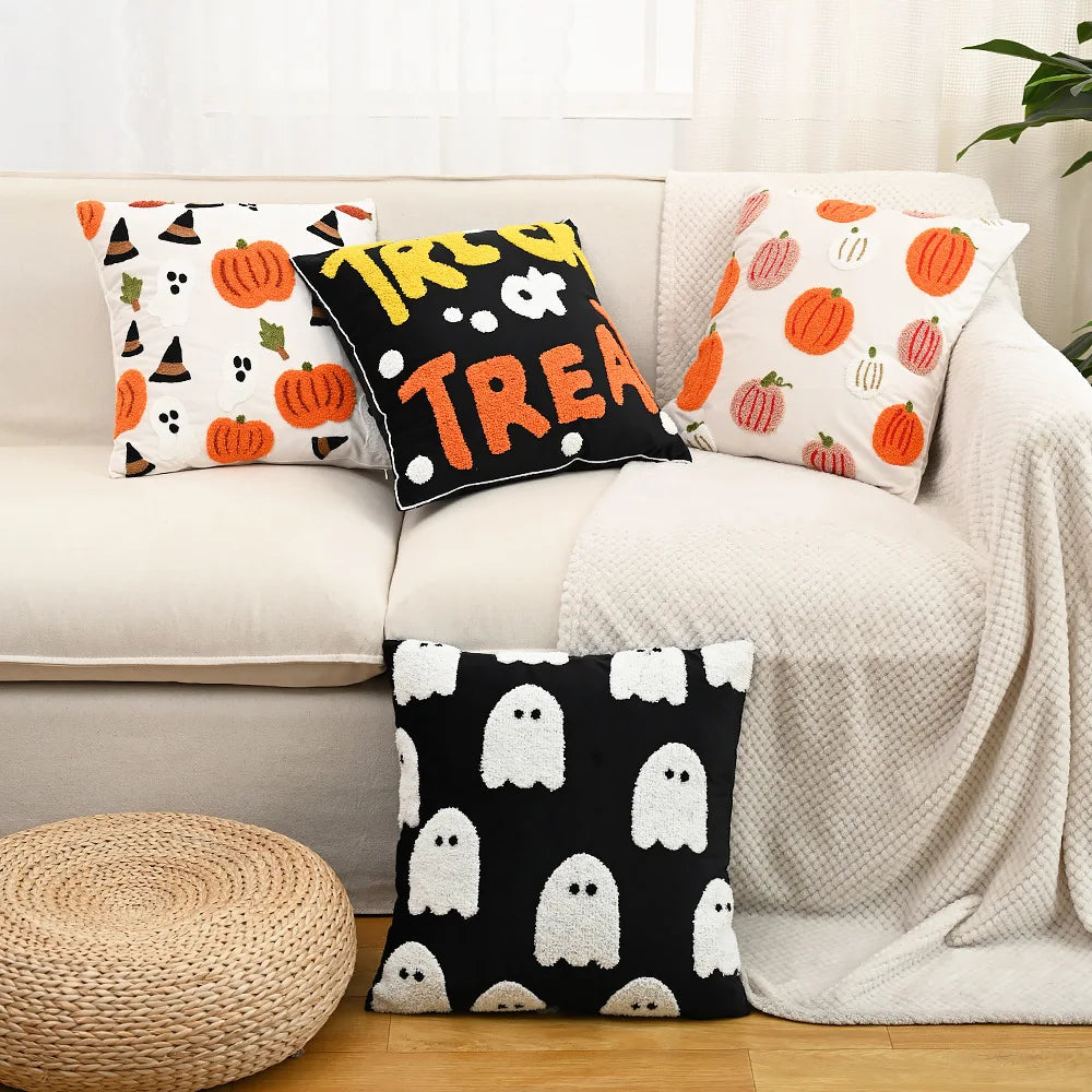 Halloween-themed pillows on a couch with a neutral background