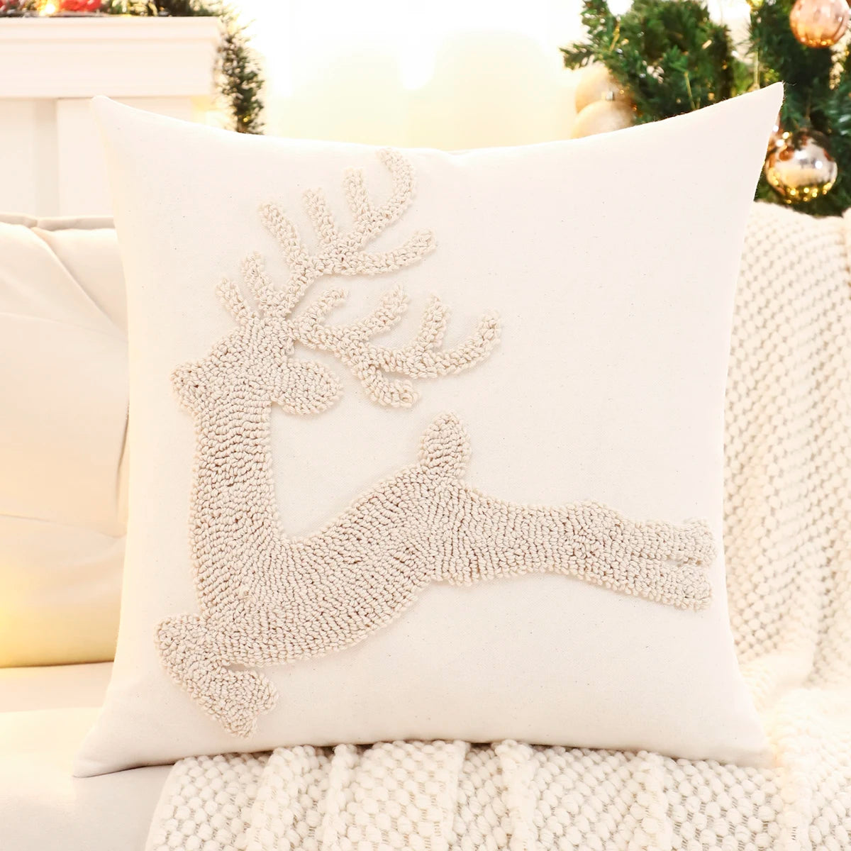 Decorative pillow with beaded reindeer design on a couch. Christmas embroidered pillow cover with tufted snowflake and reindeer design in 18x18 inches, festive canvas cushion case for sofa or bed