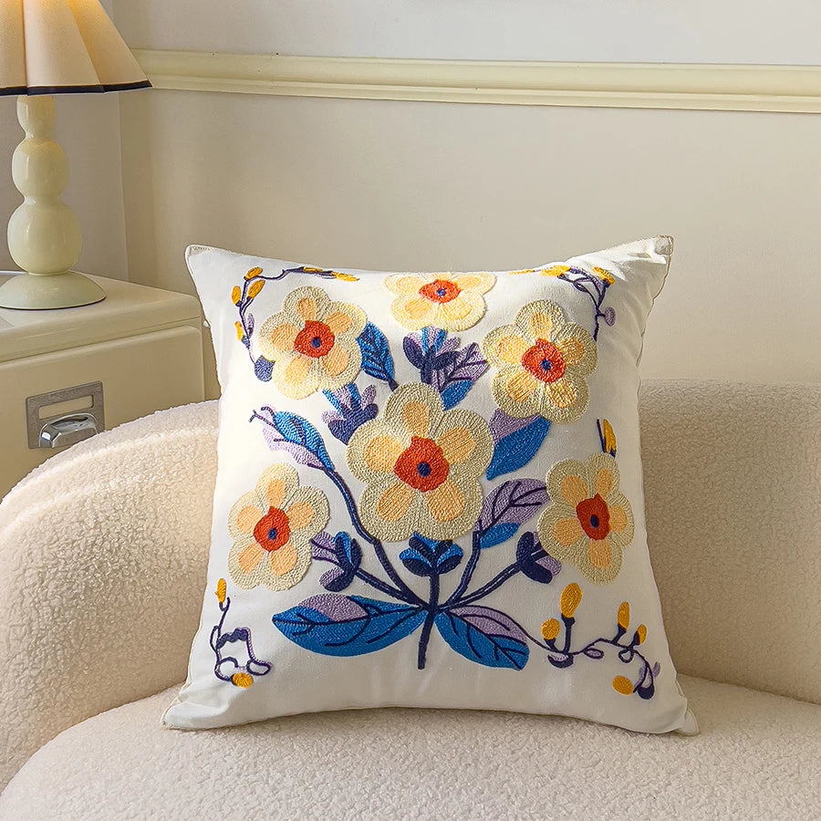 Decorative pillow with floral embroidery on a couch