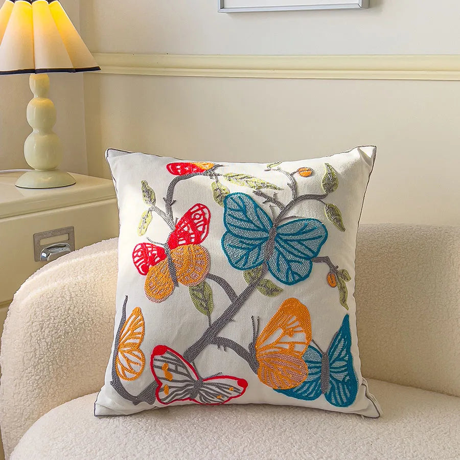 Decorative pillow with colorful butterfly design on a couch
