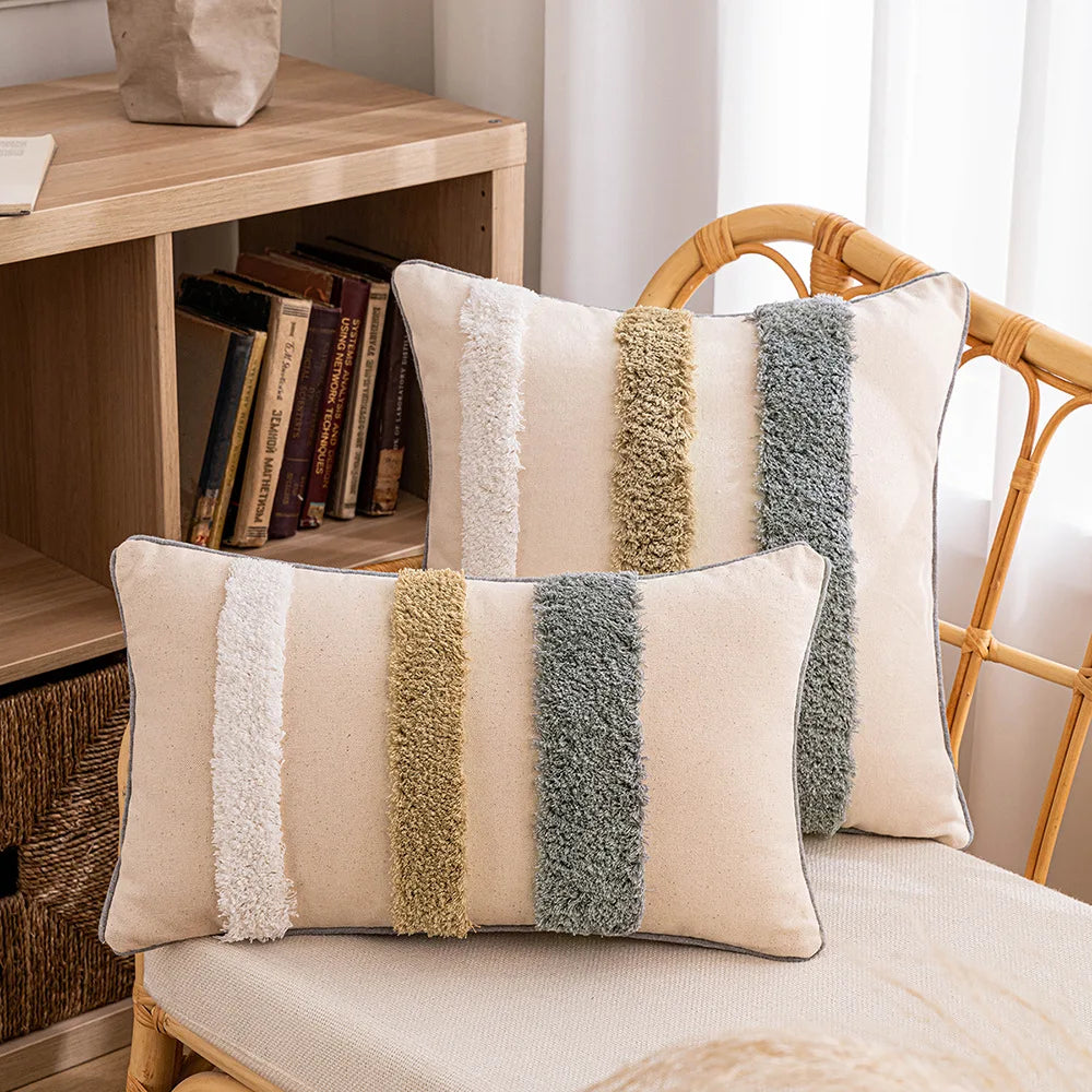 Decorative pillows with striped pattern on a chair next to a wooden shelf with books.Embroidered boho home décor pillowcase cotton blend