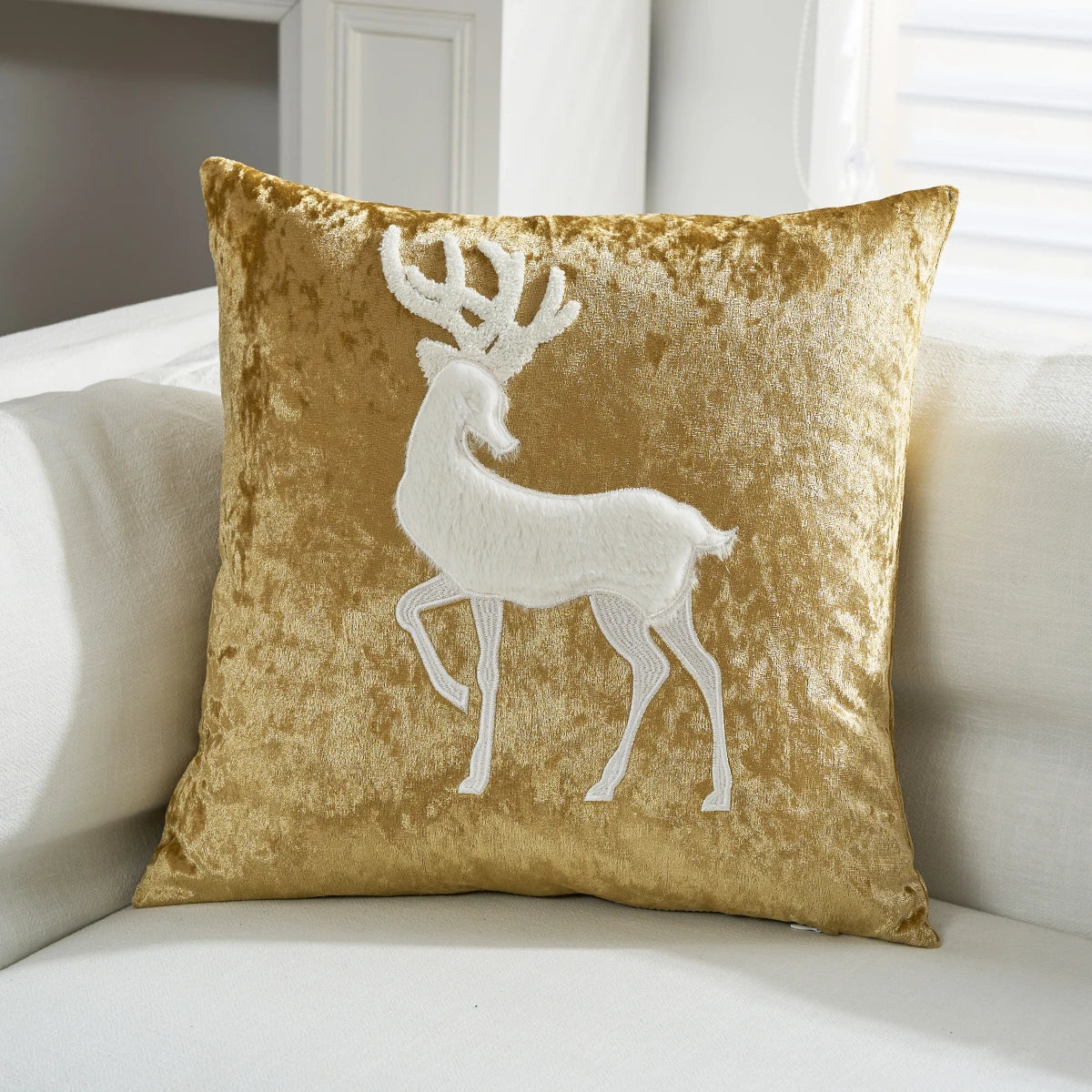 Gold pillow with a white deer design on a white couch. Christmas embroidered pillow cover in gold, 18x18 inch festive cushion case for sofa, bed, or holiday home décor. Christmas Gift Ideas