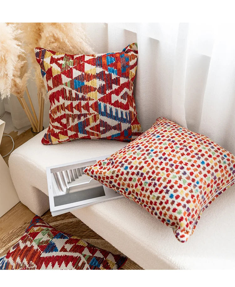 Colorful patterned cushions on a white sofa with a decorative plant in the background.Bohemian Aztec woven pillow cover, geometric jacquard cushion for sofa, bed, or living room decor in neutral cotton blend fabric.