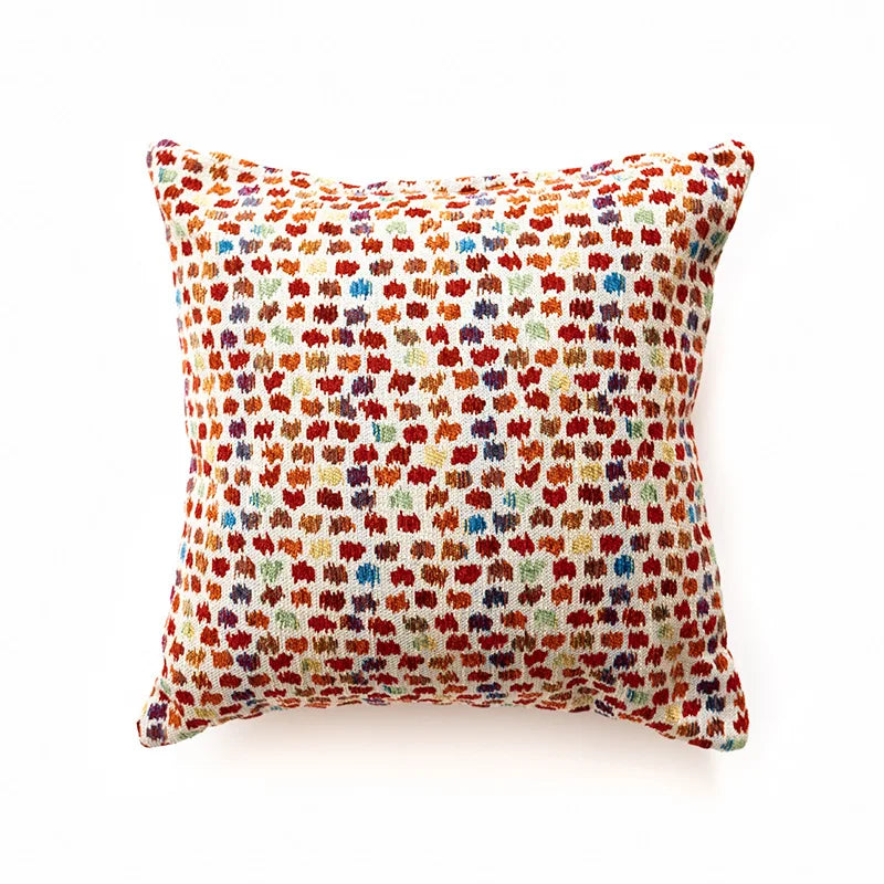 Decorative pillow with colorful pattern on a white background. Bohemian Aztec woven pillow cover, geometric jacquard cushion for sofa, bed, or living room decor in neutral cotton blend fabric.