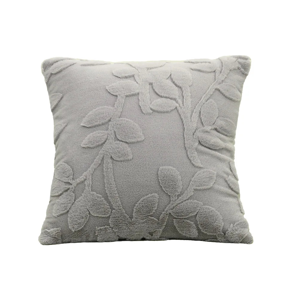 Gray decorative pillow with leaf pattern on a white background. Modern jacquard leaf throw pillow cover, woven floral decorative cushion for sofa, bed, or living room in neutral and soft tones.